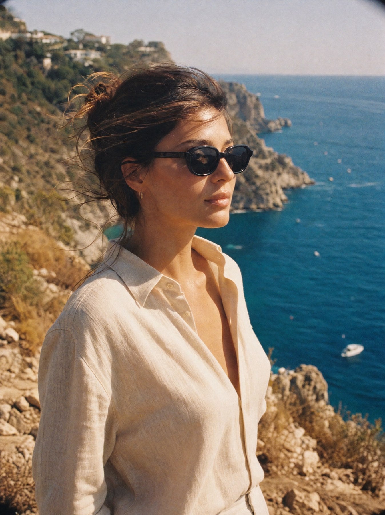 Woman wearing Saint & Sol sunglasses on a Mediterranean cliffside